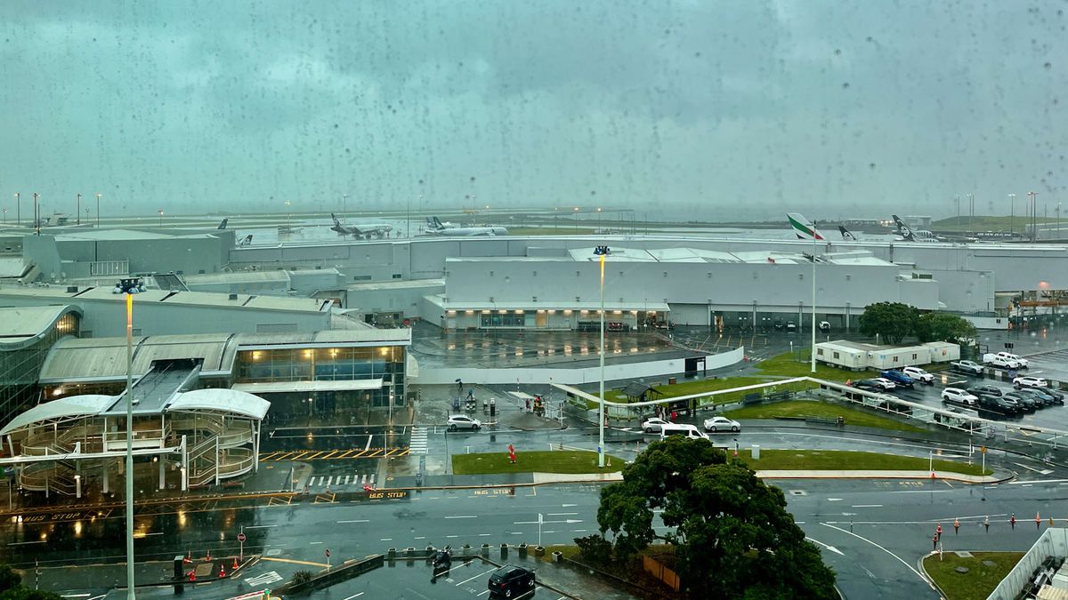 Rainy view of Auckland International Airport from a hotel room.