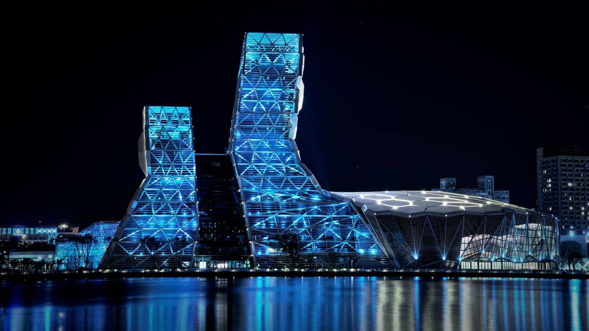Night-time view of the Kaohsiung Music Center, from across the harbor.