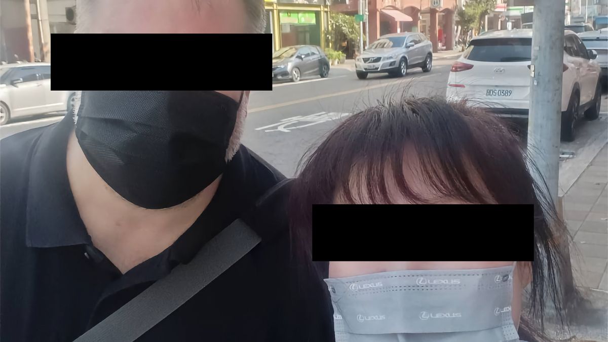 Selfie of a man and a woman, digitally altered with black boxes over their faces to conceal their identities.