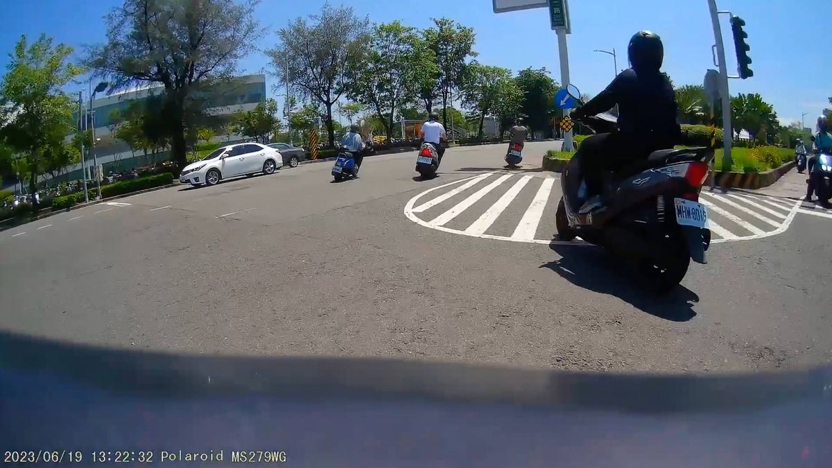 Dashcam footage of motorcycles passing the Weiwuying Arts Center building in Kaohsiung, Taiwan.