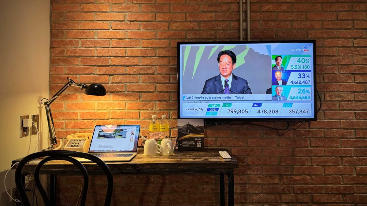 Photo of a TV in a hotel room, above a desk.