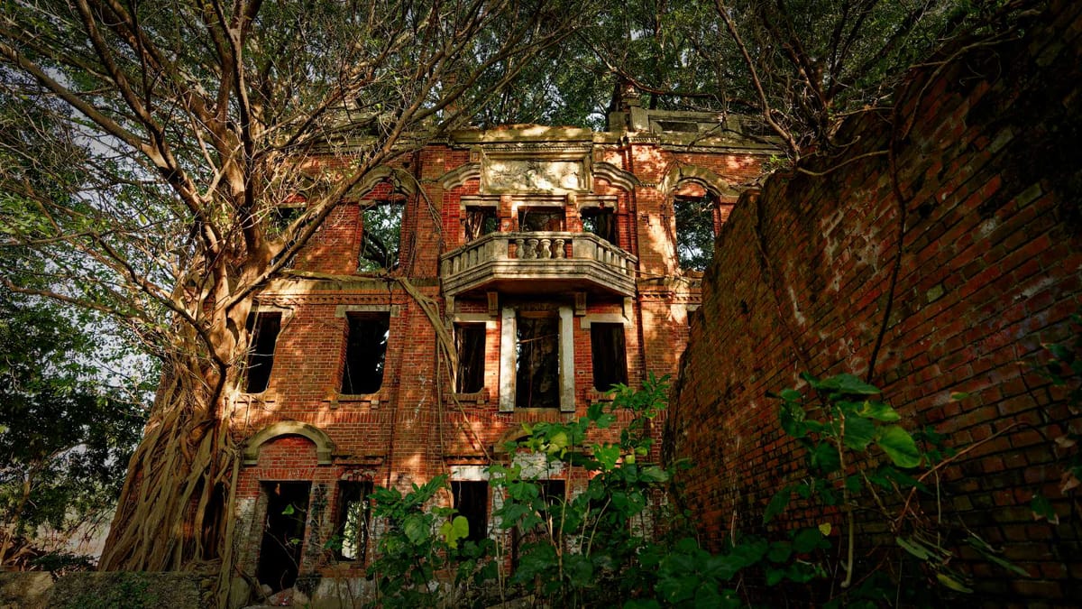 The front of Minxiong Haunted House, an abandoned three-story brick mansion a Chiayi forest in Taiwan.