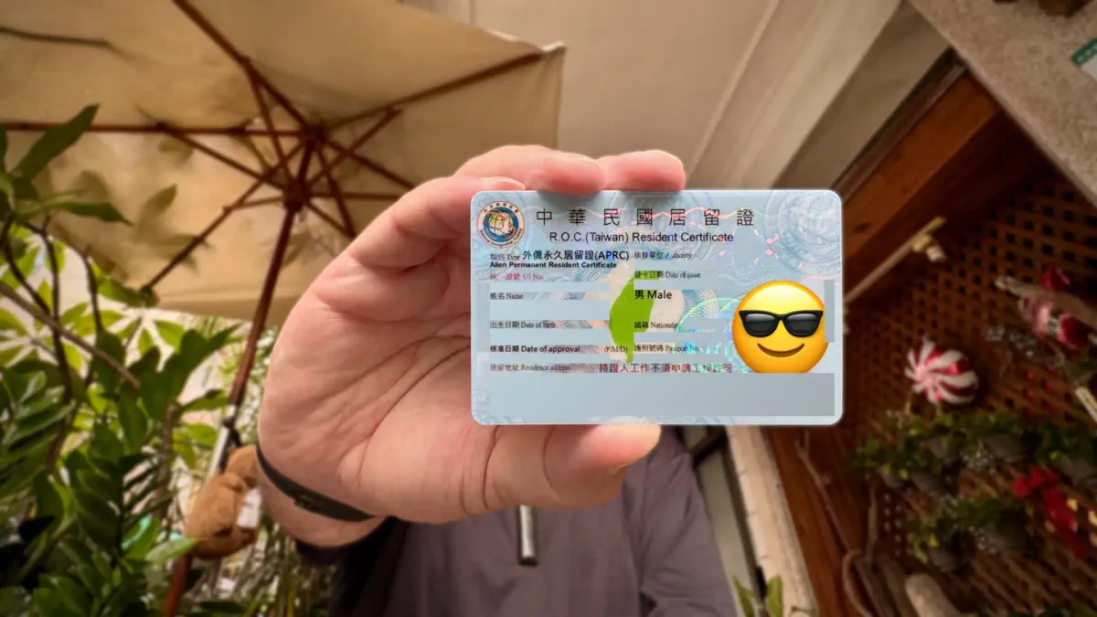 Close-up of a Taiwan Alien Permanent Resident Certificate (APRC) ID card, with personal details obscured.