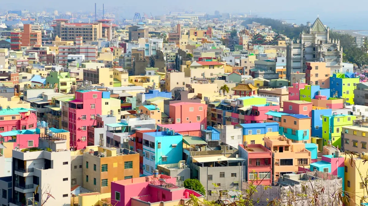 Aerial view of brightly-painted densely-packed low-rise concrete apartment buildings on Cijin Island, Kaoshiung, Taiwan.