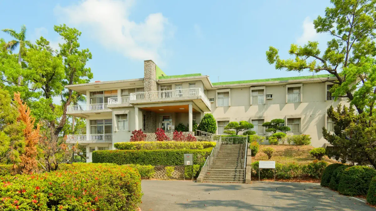 A three-level mid-century modern house surrounded by a carefully-maintained garden.